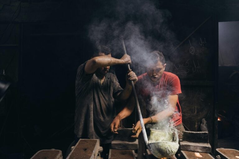 Two people cooking typical Egyptian food.