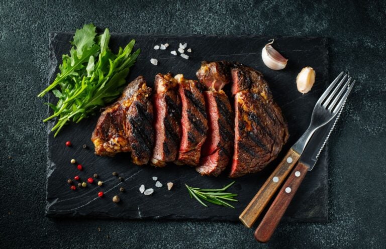 Cut flat iron steak served on a stone board