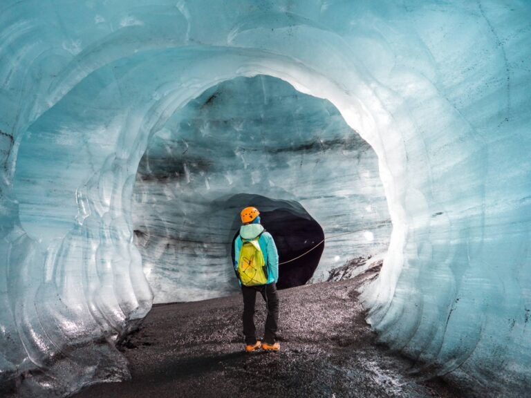 person walking inside the katla ice cave