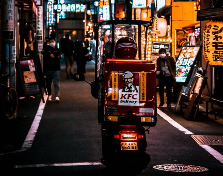 A KFC delivery rider rides through the alleys of Japan