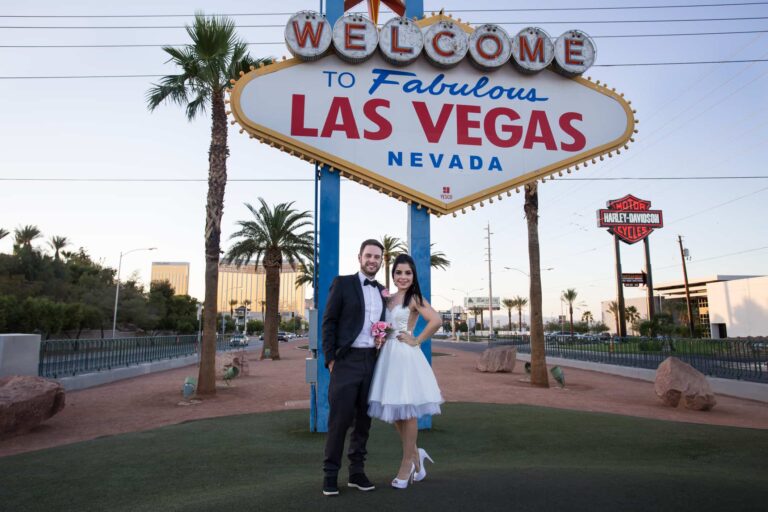 Newlyweds in front of the Las Vegas sign