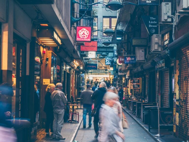 A laneway with people, shops, and cafes in Melbourne.
