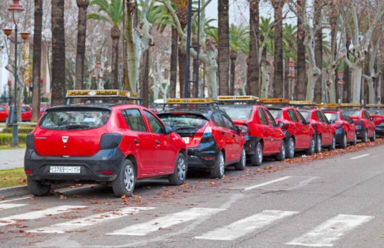 A row of red Petit Taxi in Fez