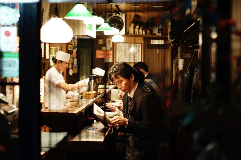 a japanese man reading a book at a Japanese restaurant 