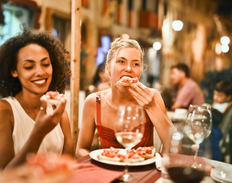 women eating bruschetta and drinking vino in an italian ristorante