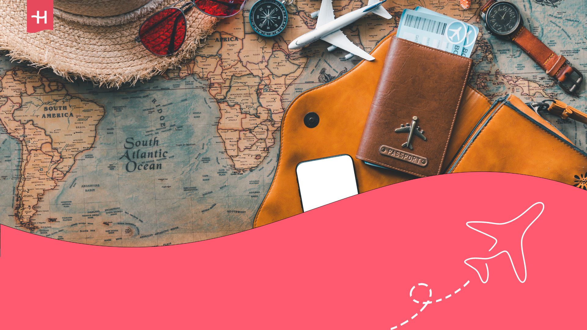 Straw hat, watch, compass, passport, a model aeroplane and sunglasses placed atop a world map.