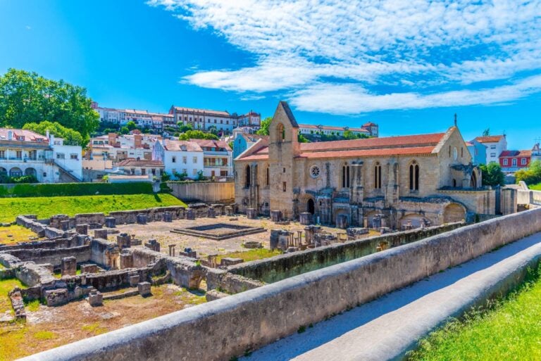old church in coimbra with traditional baroque buildings in the back