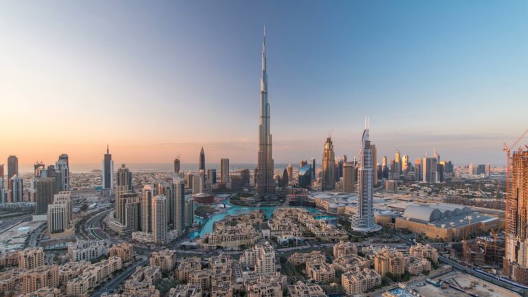 an aerial view of dubai's sky scrapers against an evening sky