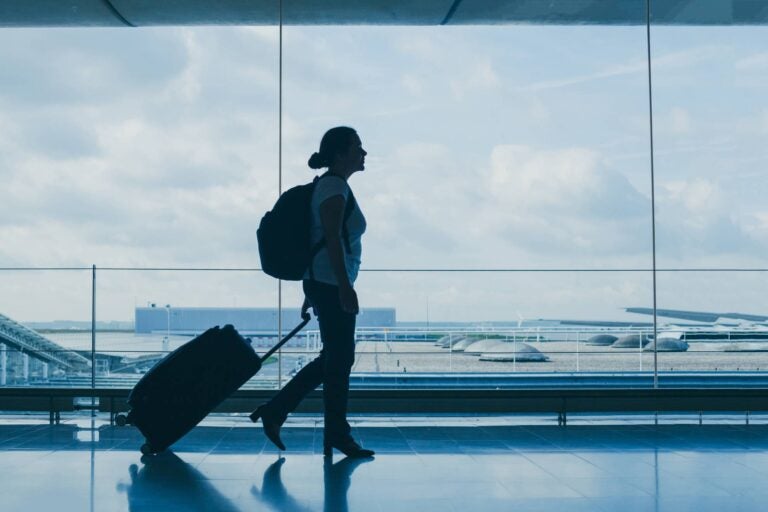 Woman walking down the airport for her next flight