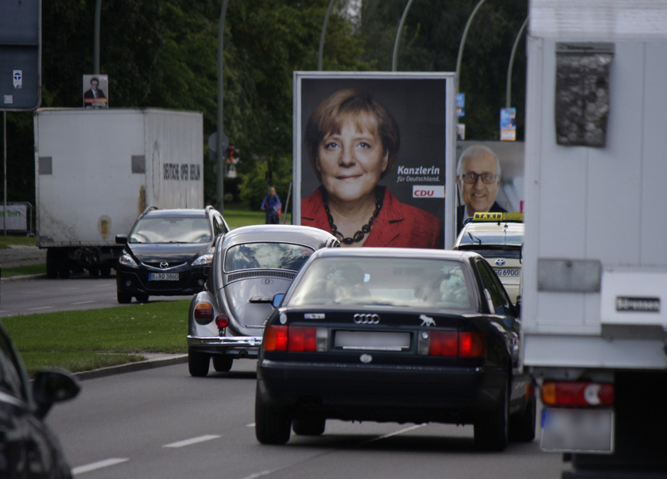 angela merkel's picture on the back of a truck