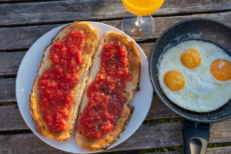 tostadas and eggs served with orange juice in seville

