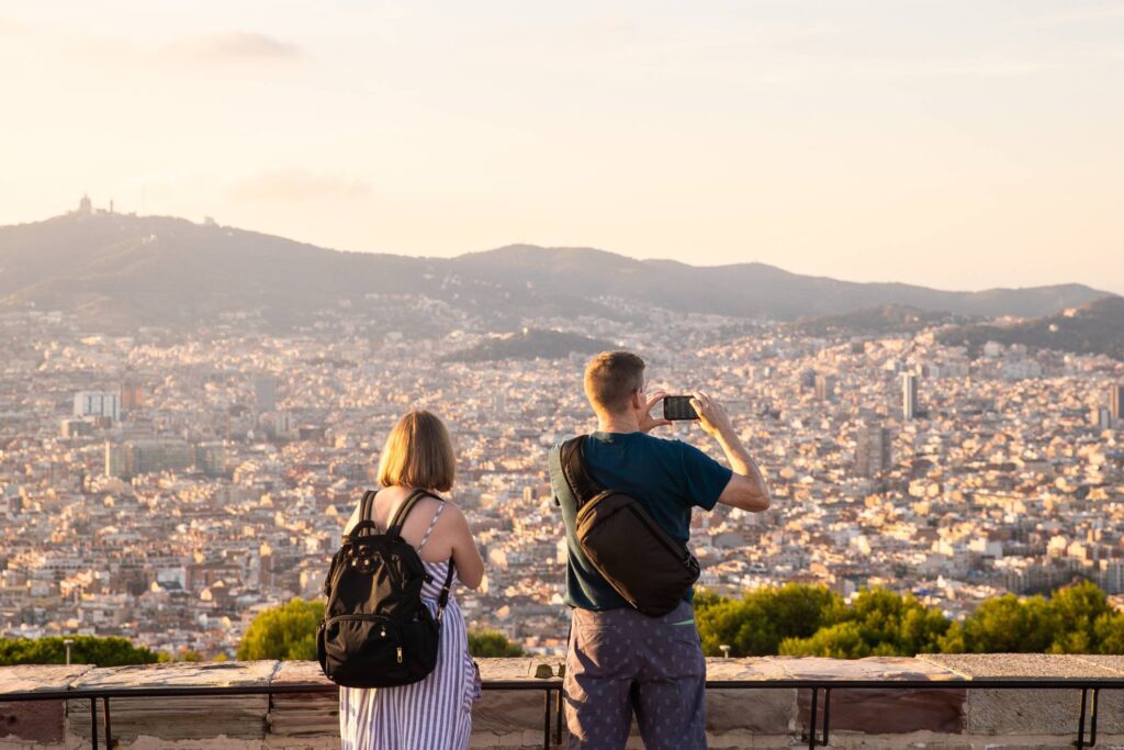 couple watching Barcelona from a hill