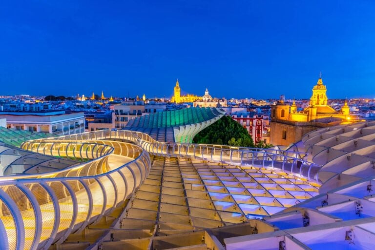 Las Setas de Seville at night with churches on the horizon