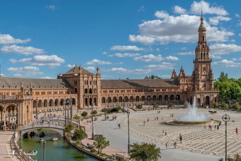 plaza de espana during a sunny day with people walking around