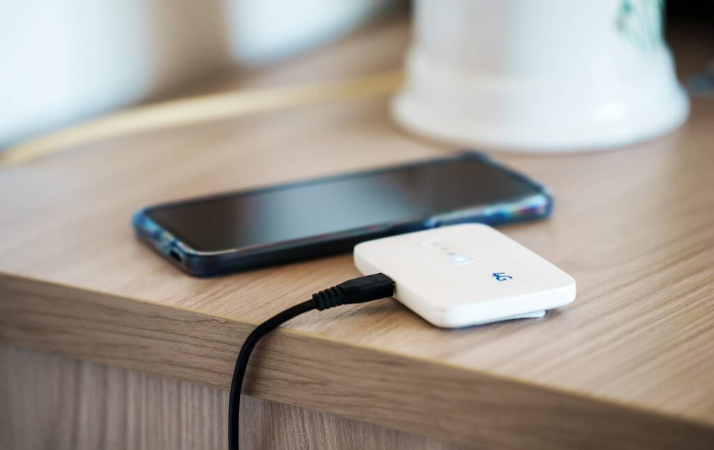 Pocket WiFi device with a phone next to it