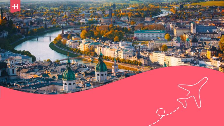 Aerial view of Vienna. Holafly logo on the top left corner and illustration of an aeroplane on the bottom right corner.