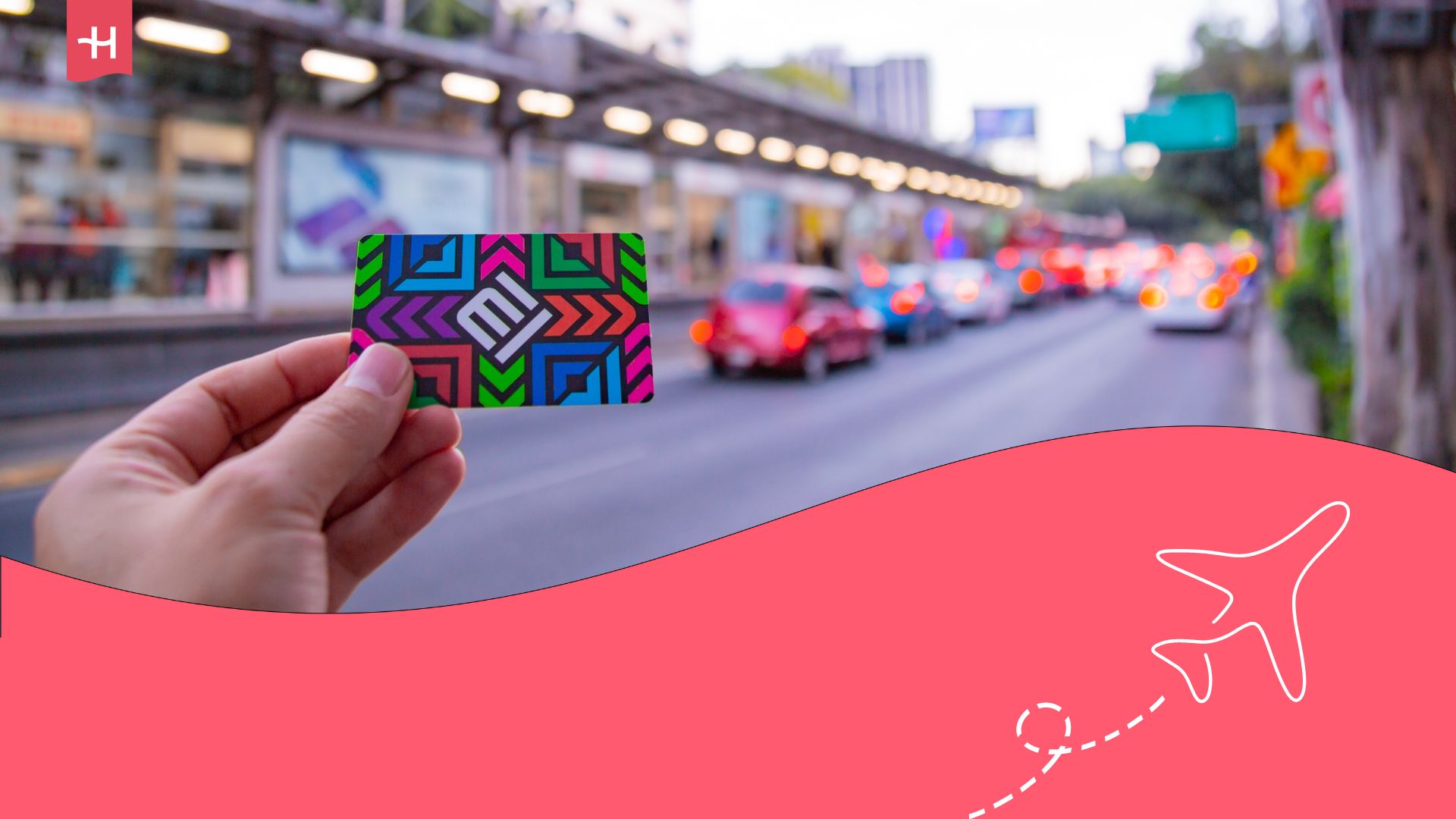 Person holding a metro card for Mexico City in front of a busy street with cars and buses passing by. Holafly logo on the top left corner, and an illustration of an aeroplane on the bottom right corner.