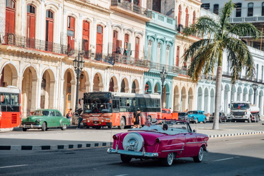 Old american cars with some local transportation vehicles