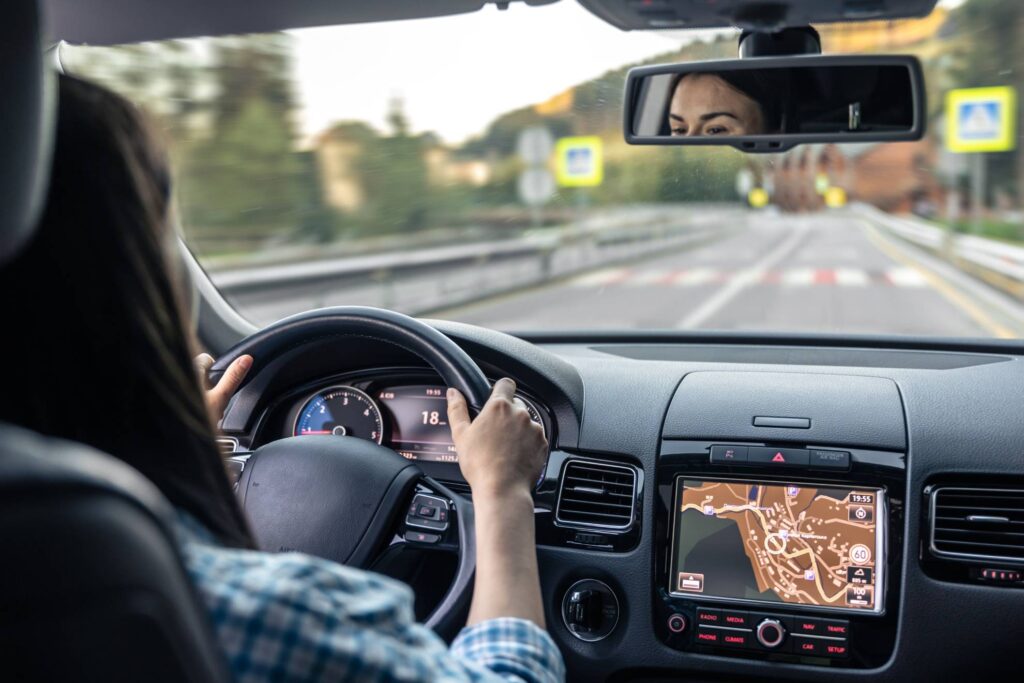 woman driving her car on the highway with a gps turned on