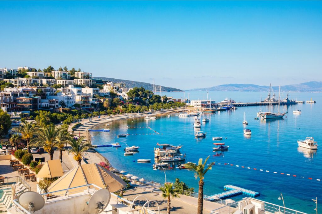 Aerial view of Bodrum and the water, with boats anchored close to the shore.
