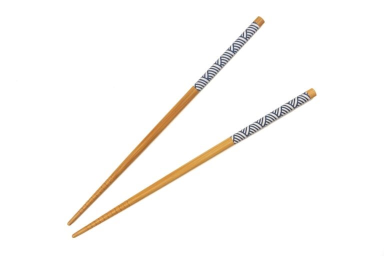 Light wooden chopsticks with dark blue and white design at the top of each stick.