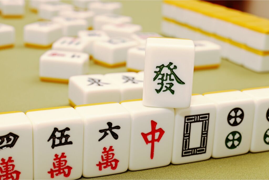 Mahjong set on a table with a gold tablecloth.