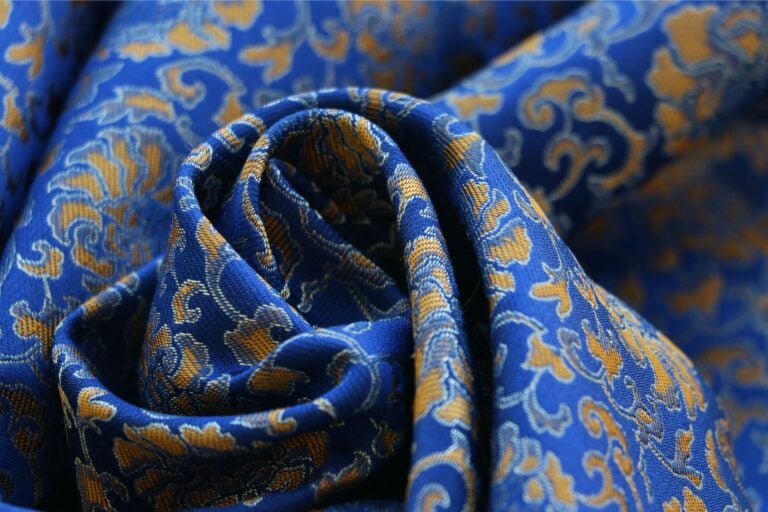 Blue, gold, and silver designed silk scarf.