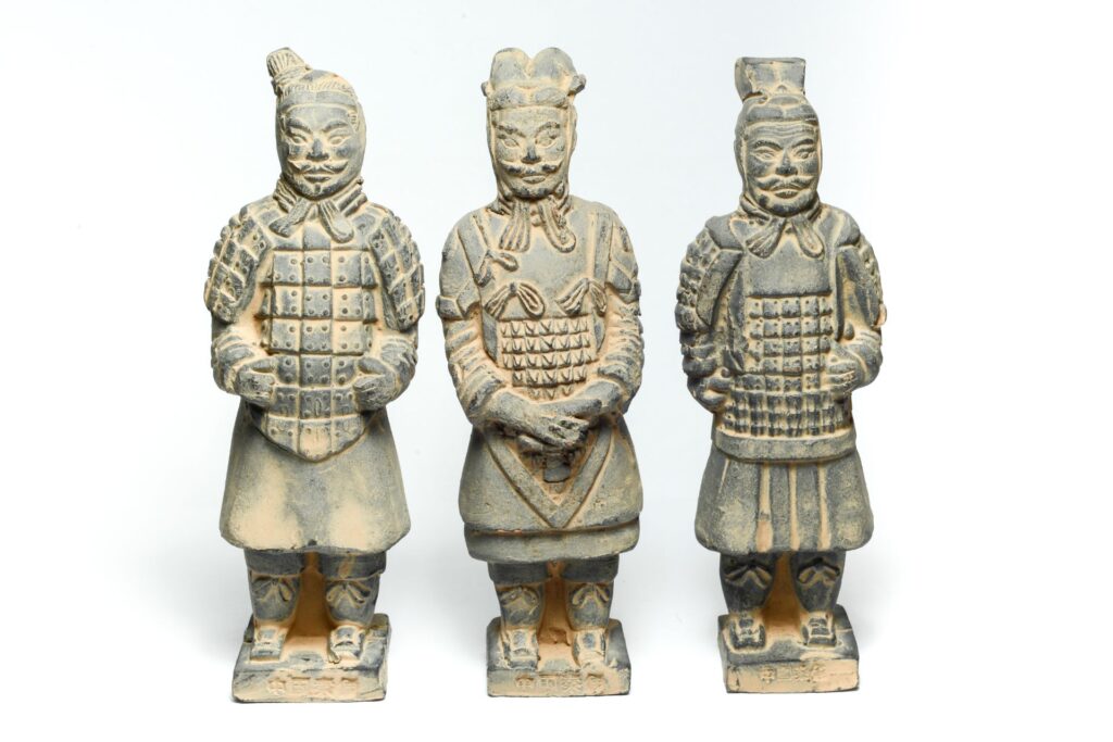 Three front facing terracotta Army statues.