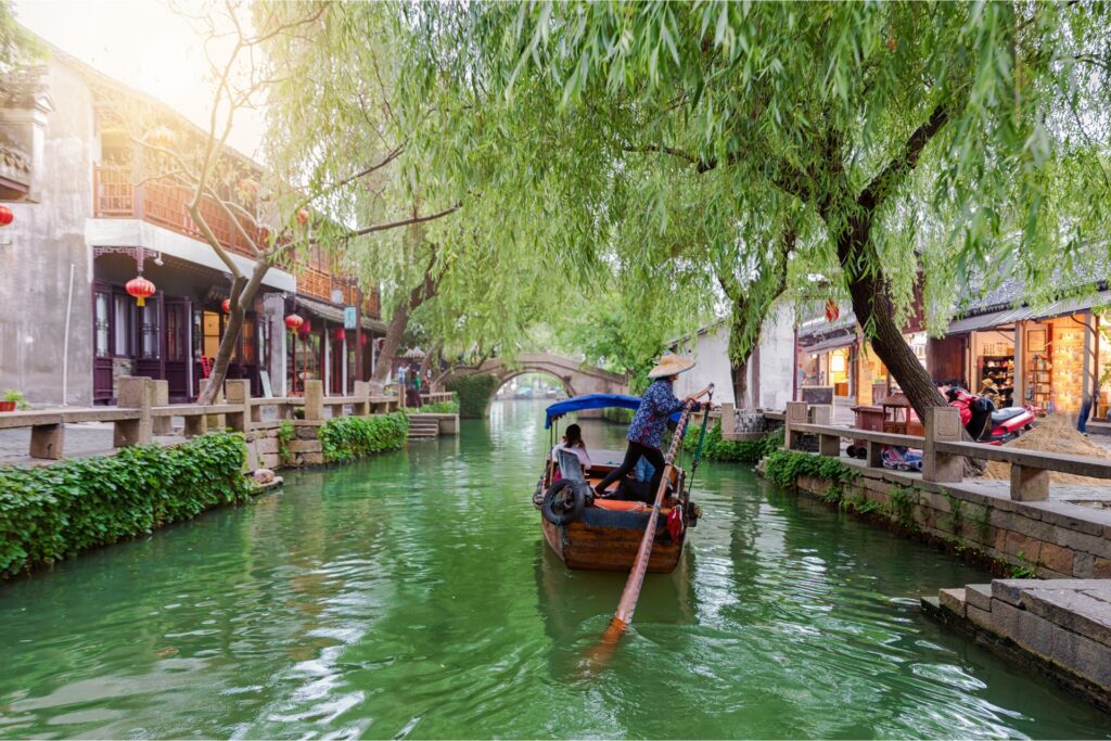 The town of Tongli's UNESCO site of Tuisi Garde and a boat sailing along the canal.