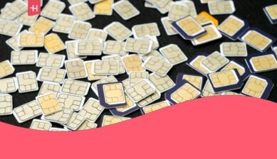 Multiple colorful physical SIM cards scattered randomly against a black background