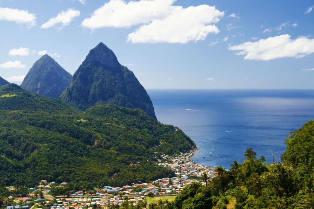 Aerial view of the Piton Mountains and the town and ocean below in St. Lucia.