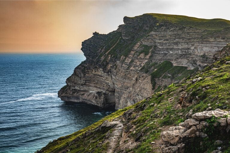 The mountains and ocean of Salalah, Oman at dusk.