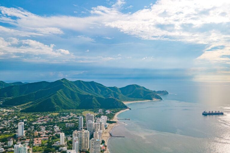 Aerial view of Santa Marta, its shoreline, and the  surrounding ocean and mountains 