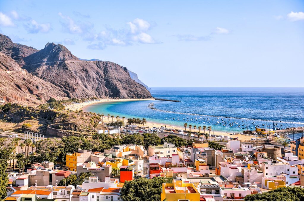 Side view of the town of Tenerife and surrounding beach and mountains.