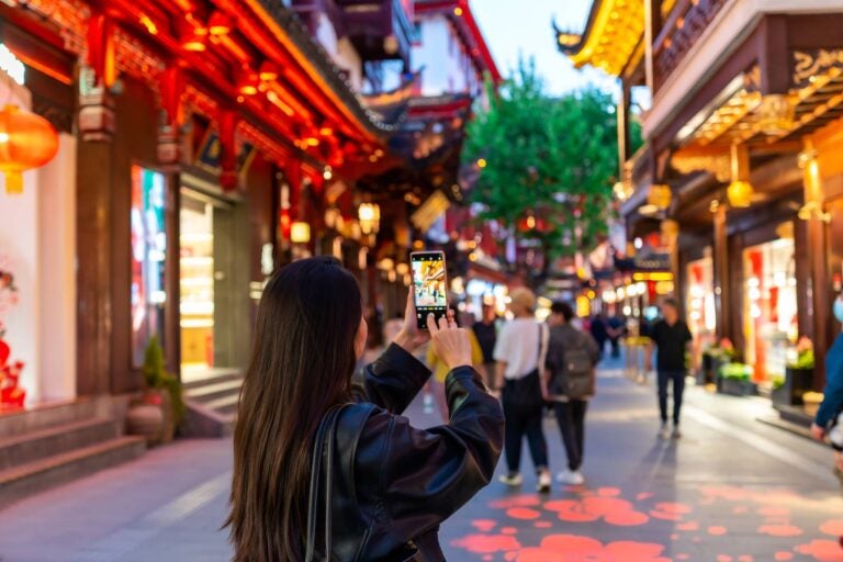 a young woman taking photos on her WhatsApp in China
