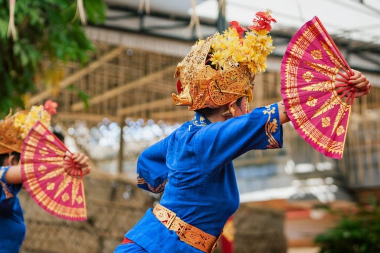 Participants in traditional Balinese attire prepare for a cultural parade at the Denpasar Festival.