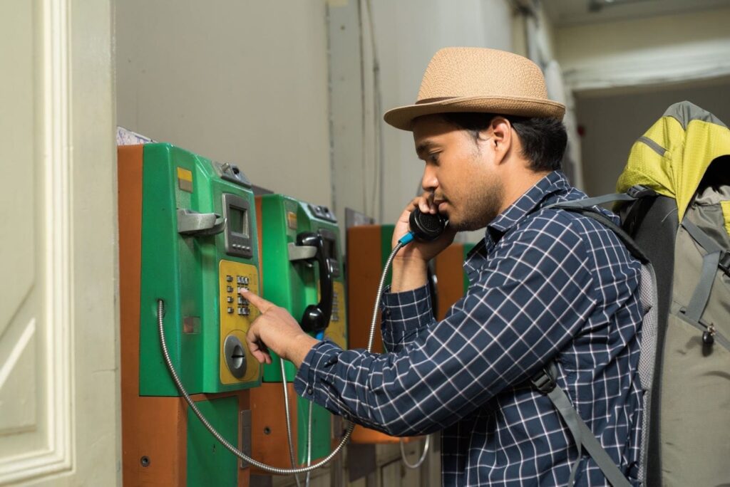 man calling at a public phonebooth