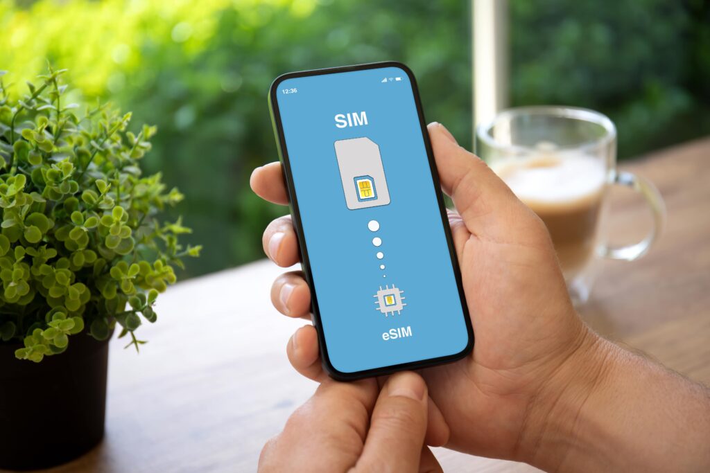 A person's hands holding a mobile phone. SIM vs eSIM for internet providers in the UK