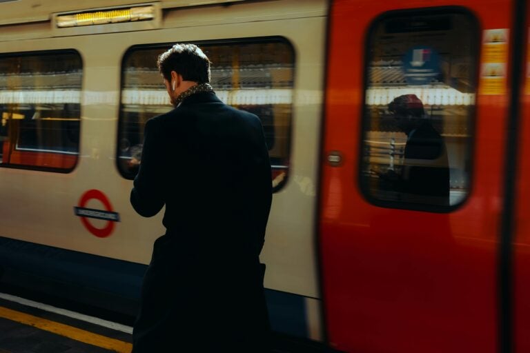 London tube platform with student and train, representing UK student travel discounts.