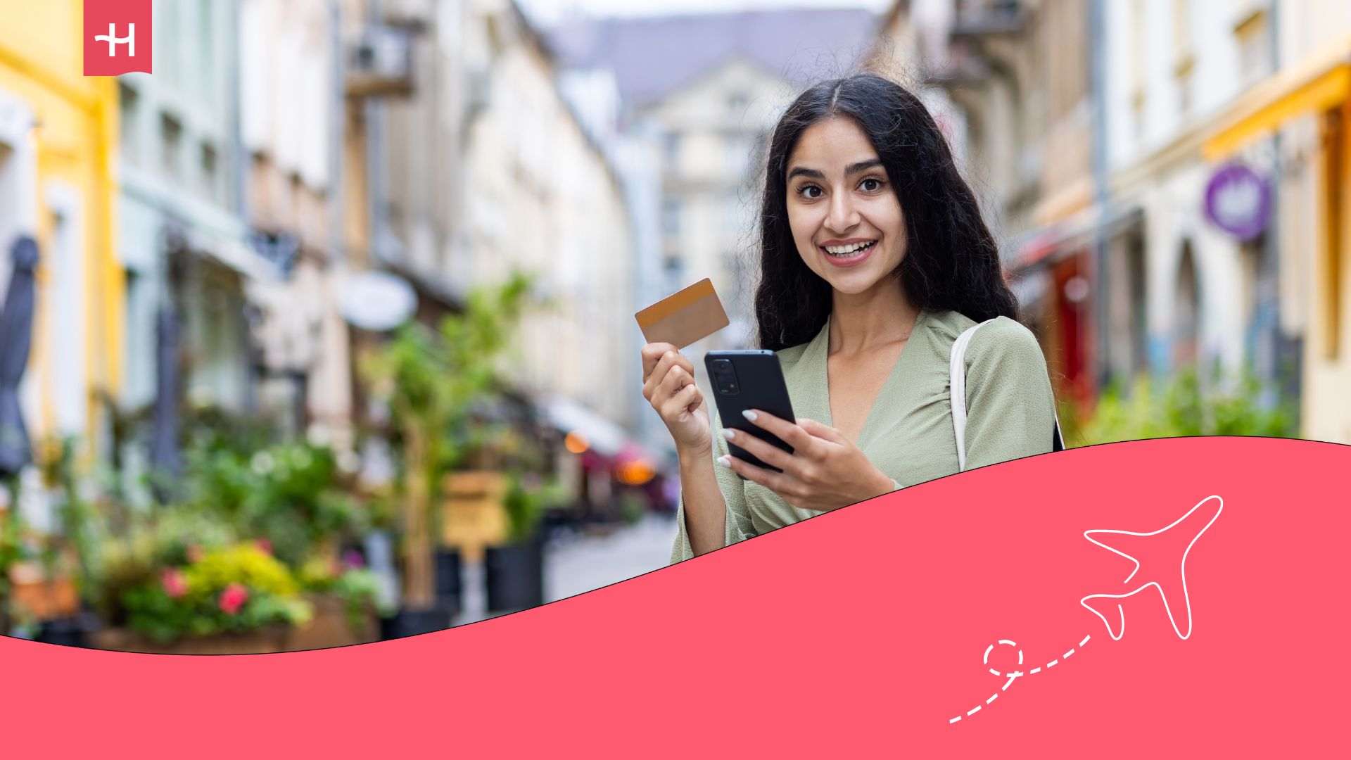 happy girl holding her credit card and mobile phone is out shopping