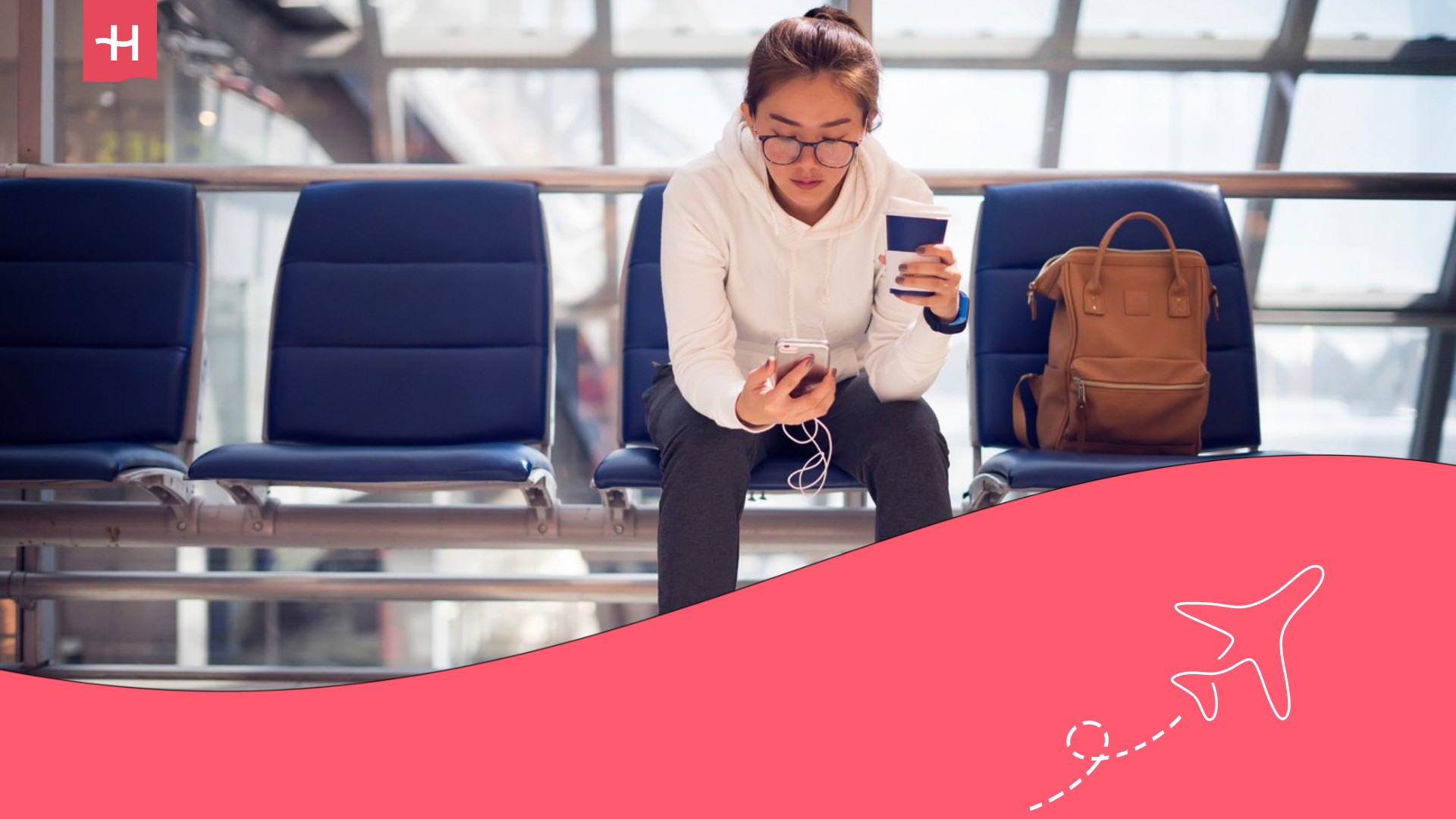 digital nomad in an airport on her phone