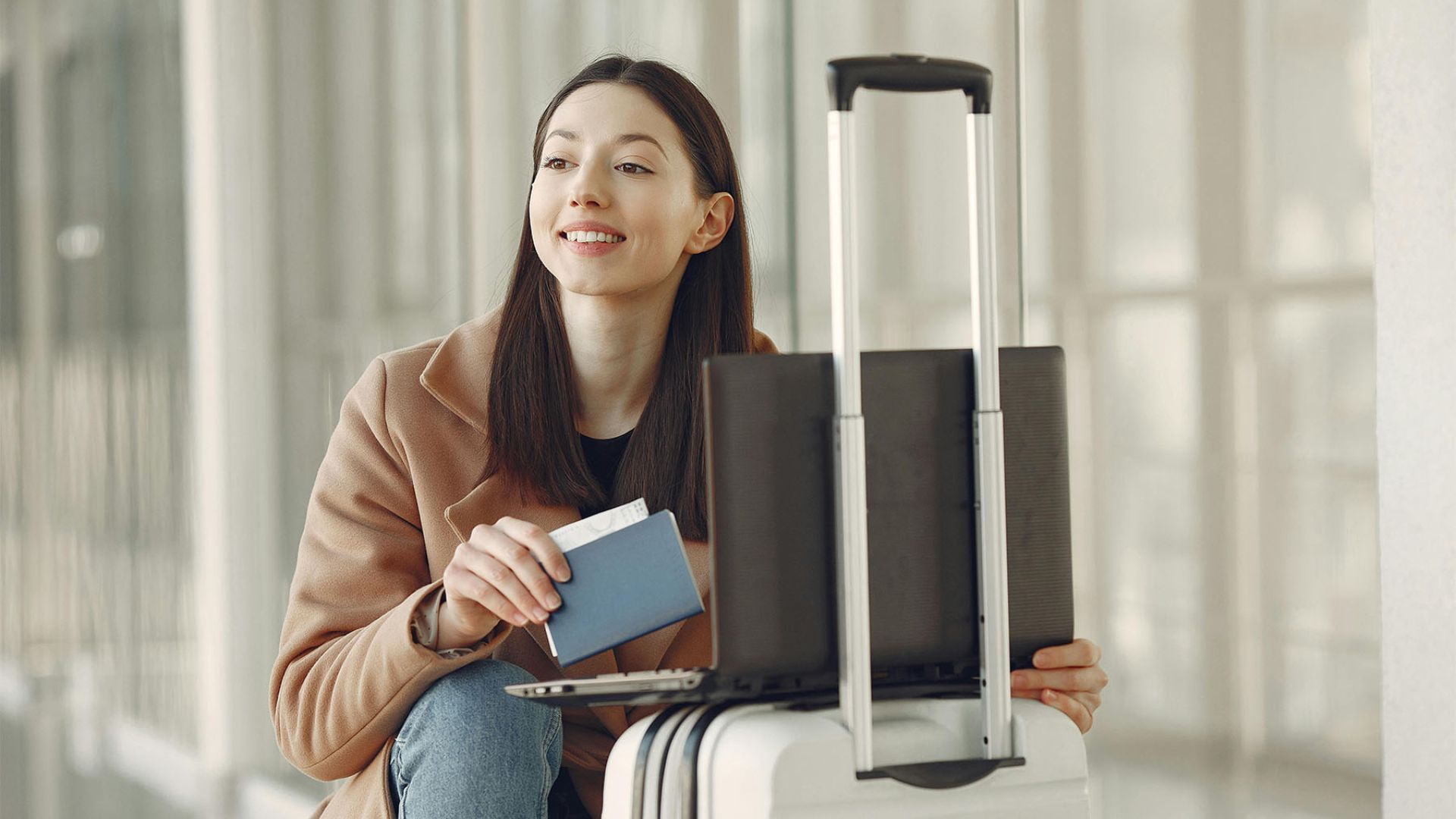 a young woman with her passport and bags at the airport