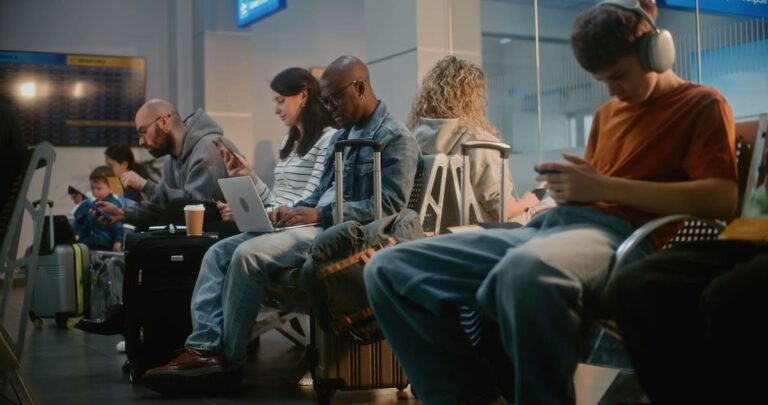 people using smartphone waiting for an airplane