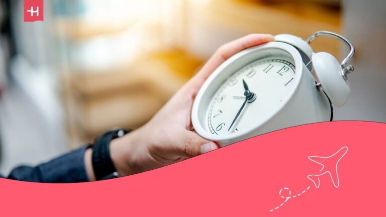 student holding a stopwatch while tracking study time