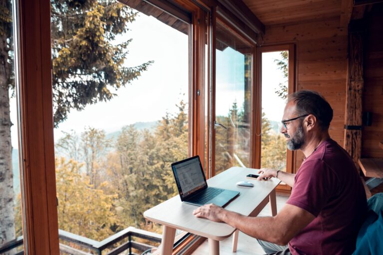man working remotely from a cabin in the mountains