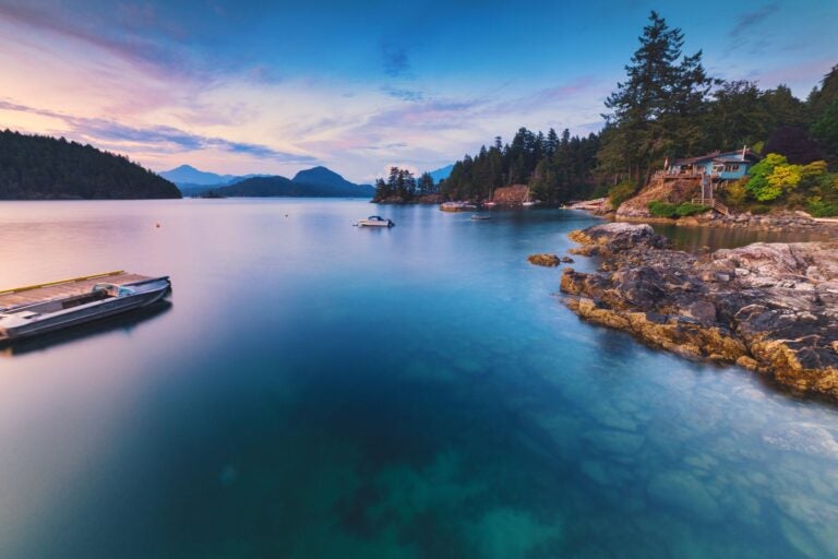 Sunset rocky beach scenes at sunset with mountains.