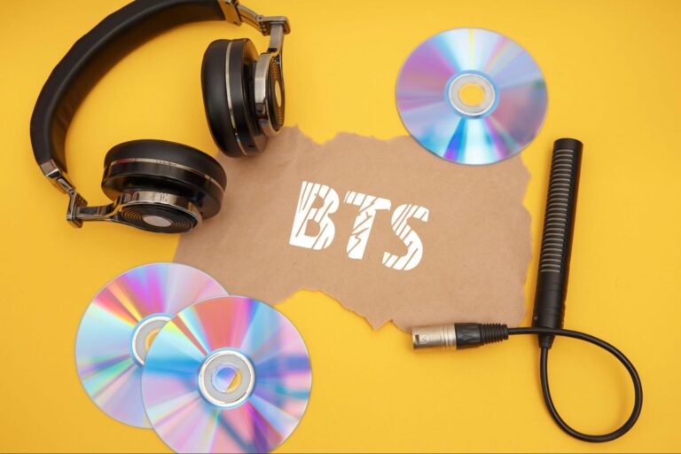 BTS concept with headphones and music discs on a yellow background