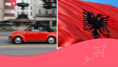 Flag of Albania and red car driving.