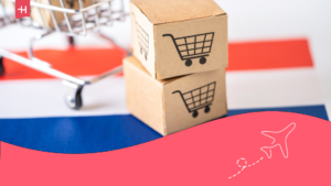Shopping trolley covered with the Dutch flag and some boxes.