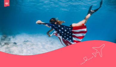 Woman with the American flag diving in Miami.